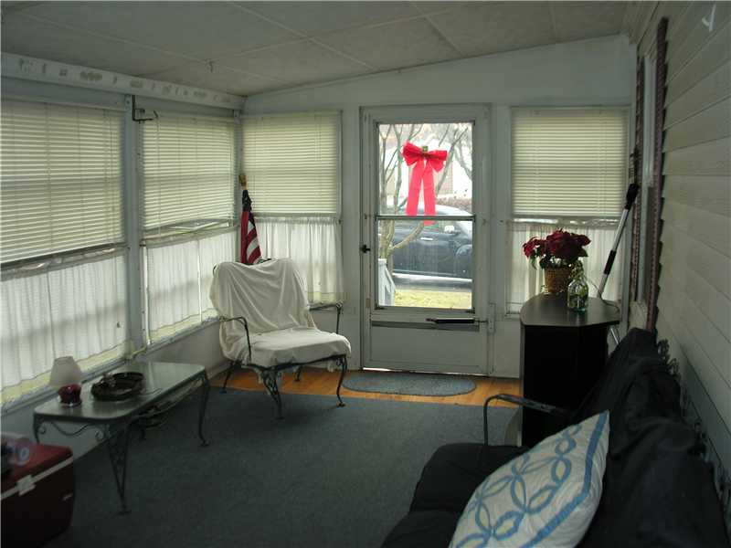 31 Woodward Road Lincoln, RI 02865 - Photo 7 of 8 Porch. Enclosed three season porch has storm windows and lots of light. Screens let in fresh air for a relaxing summer afternoon.