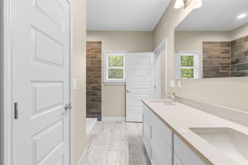1011 Southeast County Road Corsicana, TX 75109 - Photo 20 of 40 a view of a kitchen with a sink and dishwasher with wooden floor