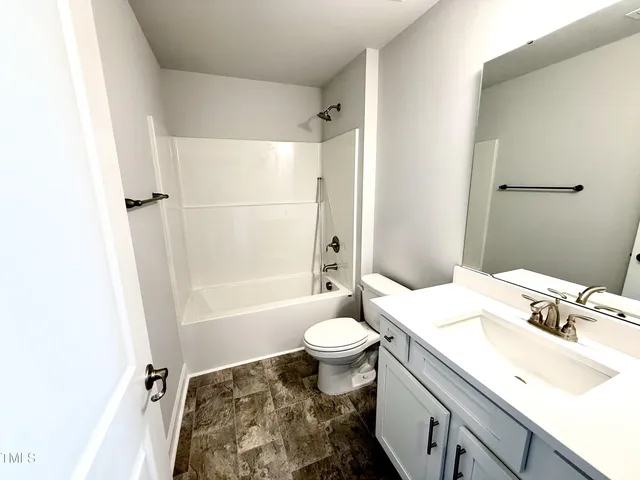 a bathroom with a sink toilet tub and shower