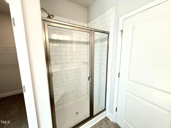 a bathroom with a glass shower door