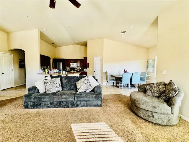 a living room with furniture and a kitchen view