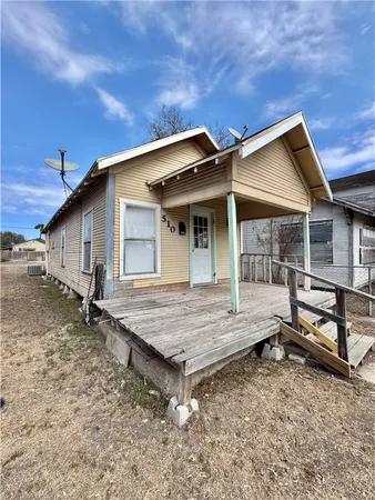 a backyard of a house with table and chairs