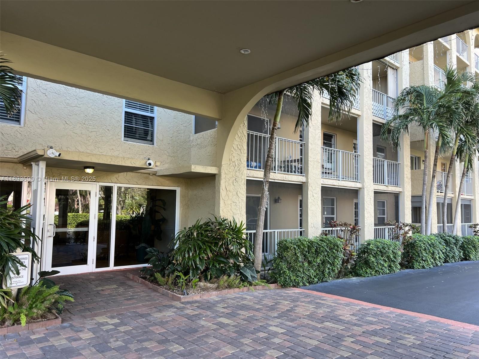 950 Ponce De Leon Road, Unit 2100 Boca Raton, FL 33432 - Photo 2 of 15 a view of a building with a garden