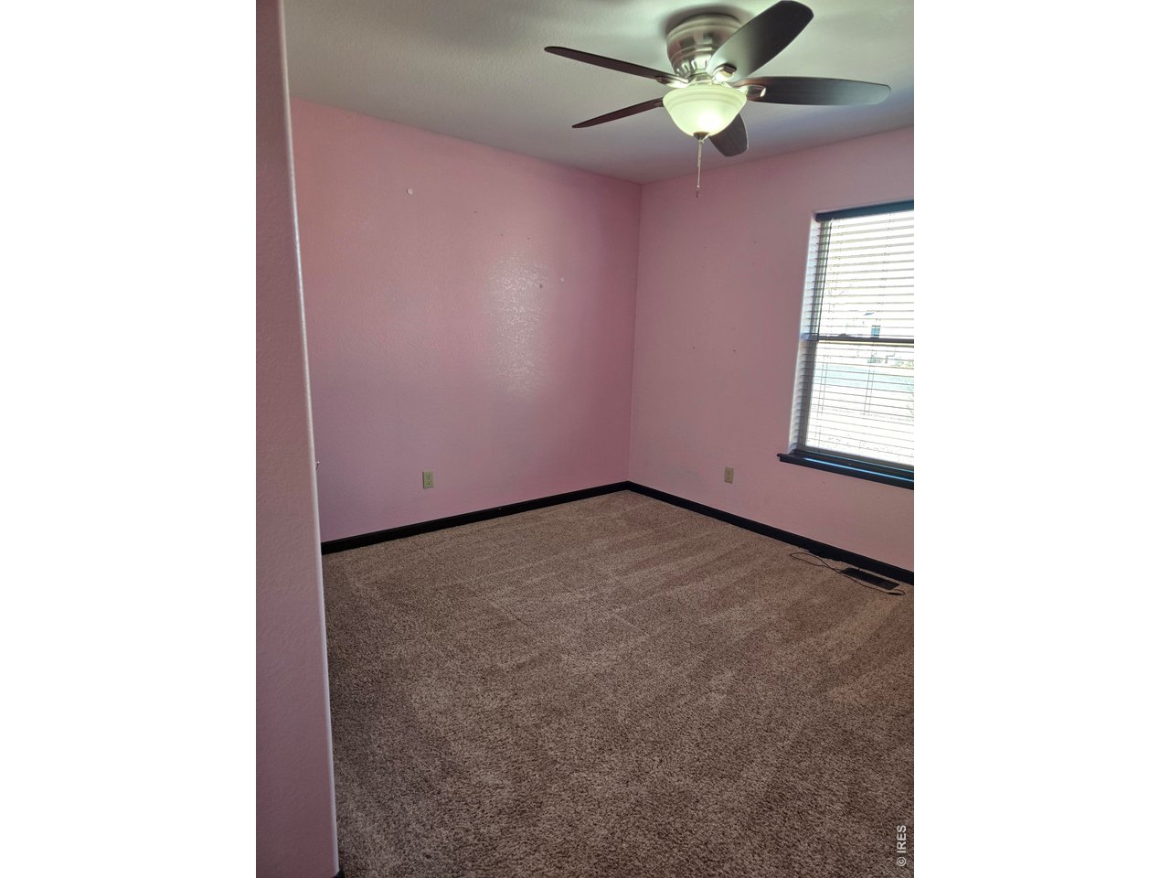 14846 Bluestem Street Sterling, CO 80751 - Photo 11 of 28 a view of an empty room with a window