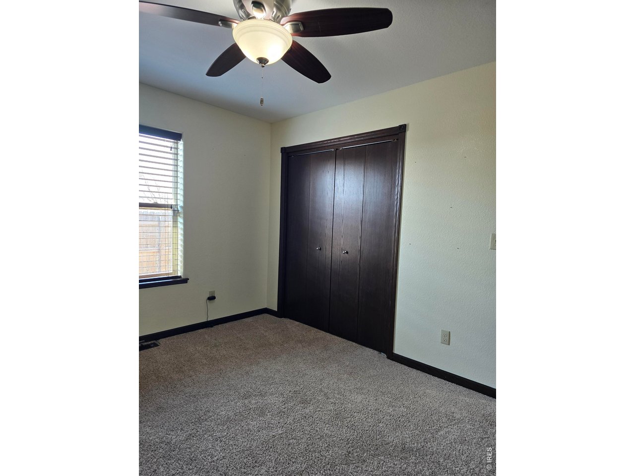 14846 Bluestem Street Sterling, CO 80751 - Photo 14 of 28 a view of an empty room with a window