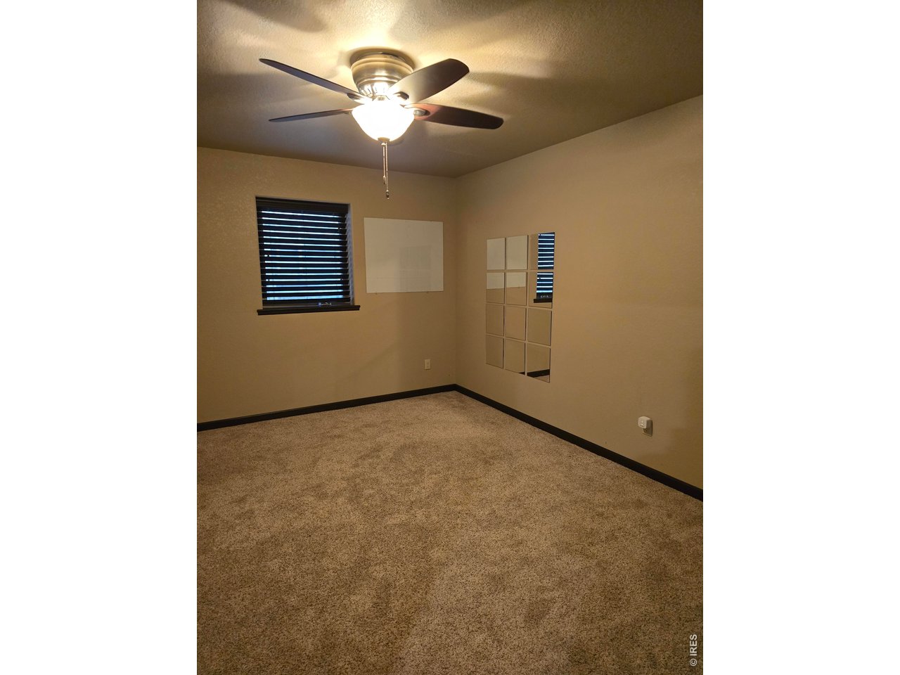 14846 Bluestem Street Sterling, CO 80751 - Photo 16 of 28 a view of an empty room with a chandelier