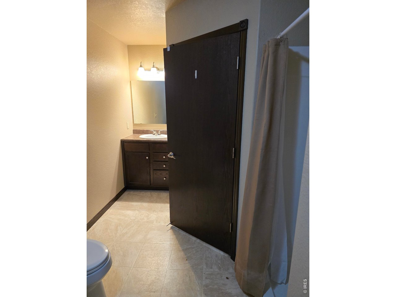 14846 Bluestem Street Sterling, CO 80751 - Photo 19 of 28 a bathroom with a granite countertop sink and a mirror