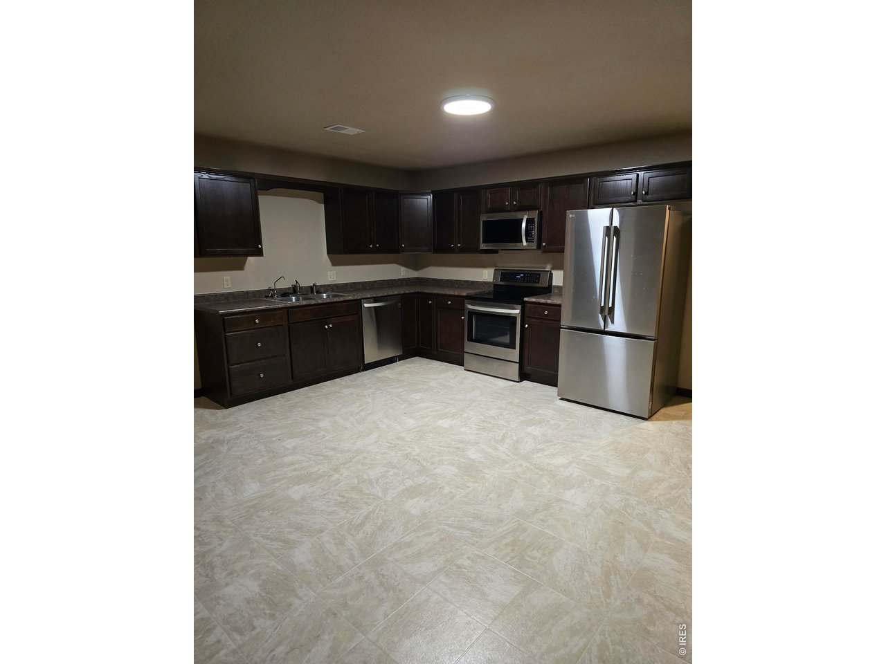 14846 Bluestem Street Sterling, CO 80751 - Photo 21 of 28 a kitchen with stainless steel appliances a refrigerator and a stove top oven