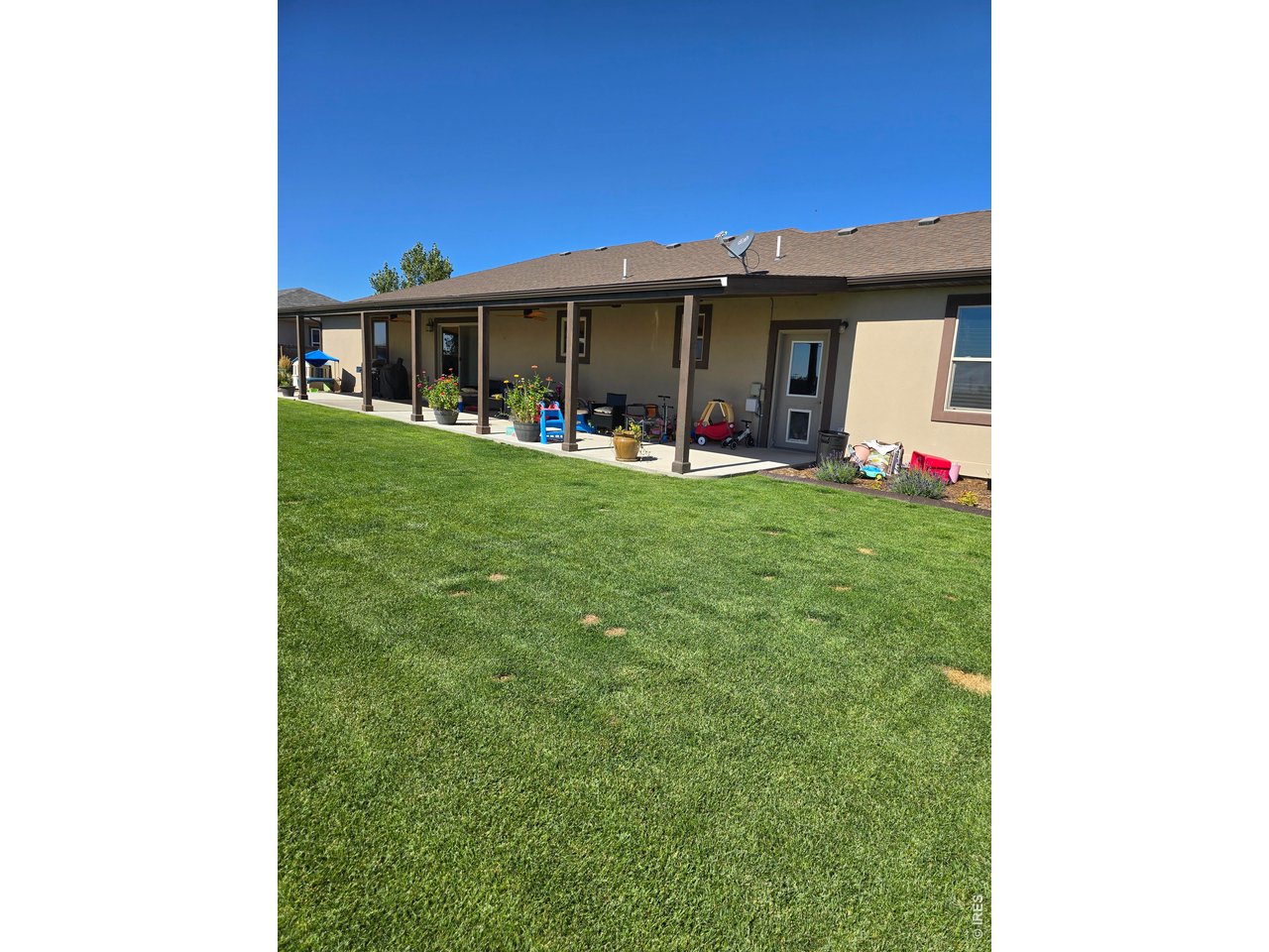 14846 Bluestem Street Sterling, CO 80751 - Photo 25 of 28 a view of a house with backyard and porch