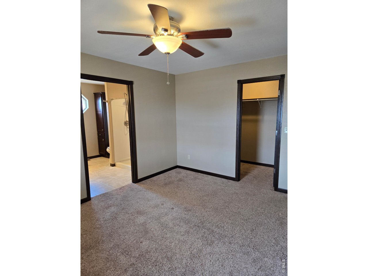 14846 Bluestem Street Sterling, CO 80751 - Photo 6 of 28 a view of a room with a ceiling fan and a bathroom