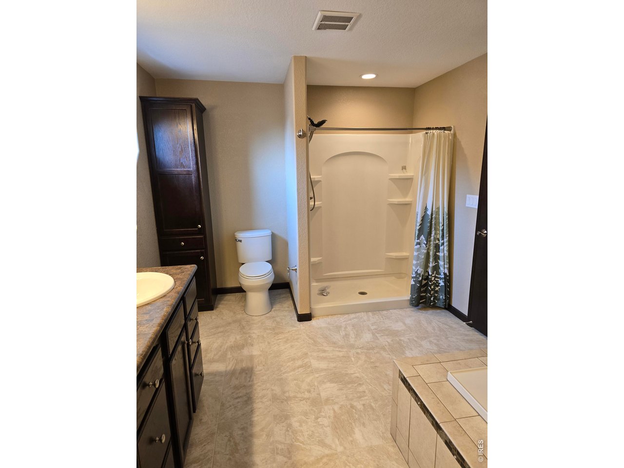 14846 Bluestem Street Sterling, CO 80751 - Photo 7 of 28 a bathroom with a sink and a mirror