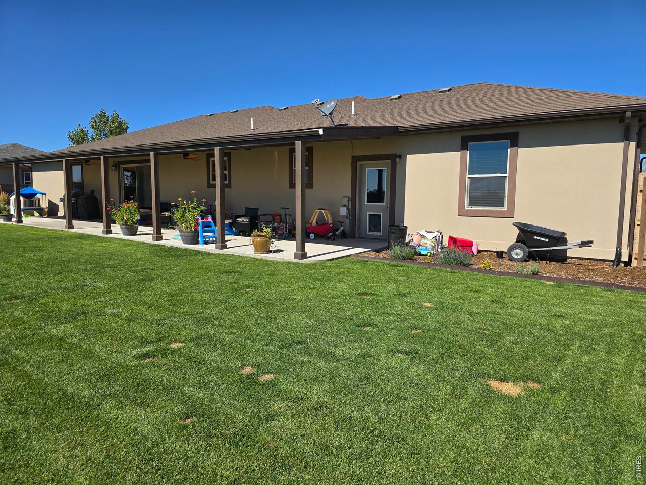 14846 Bluestem Street Sterling, CO 80751 - Photo 8 of 28 a view of a house with backyard porch and garden