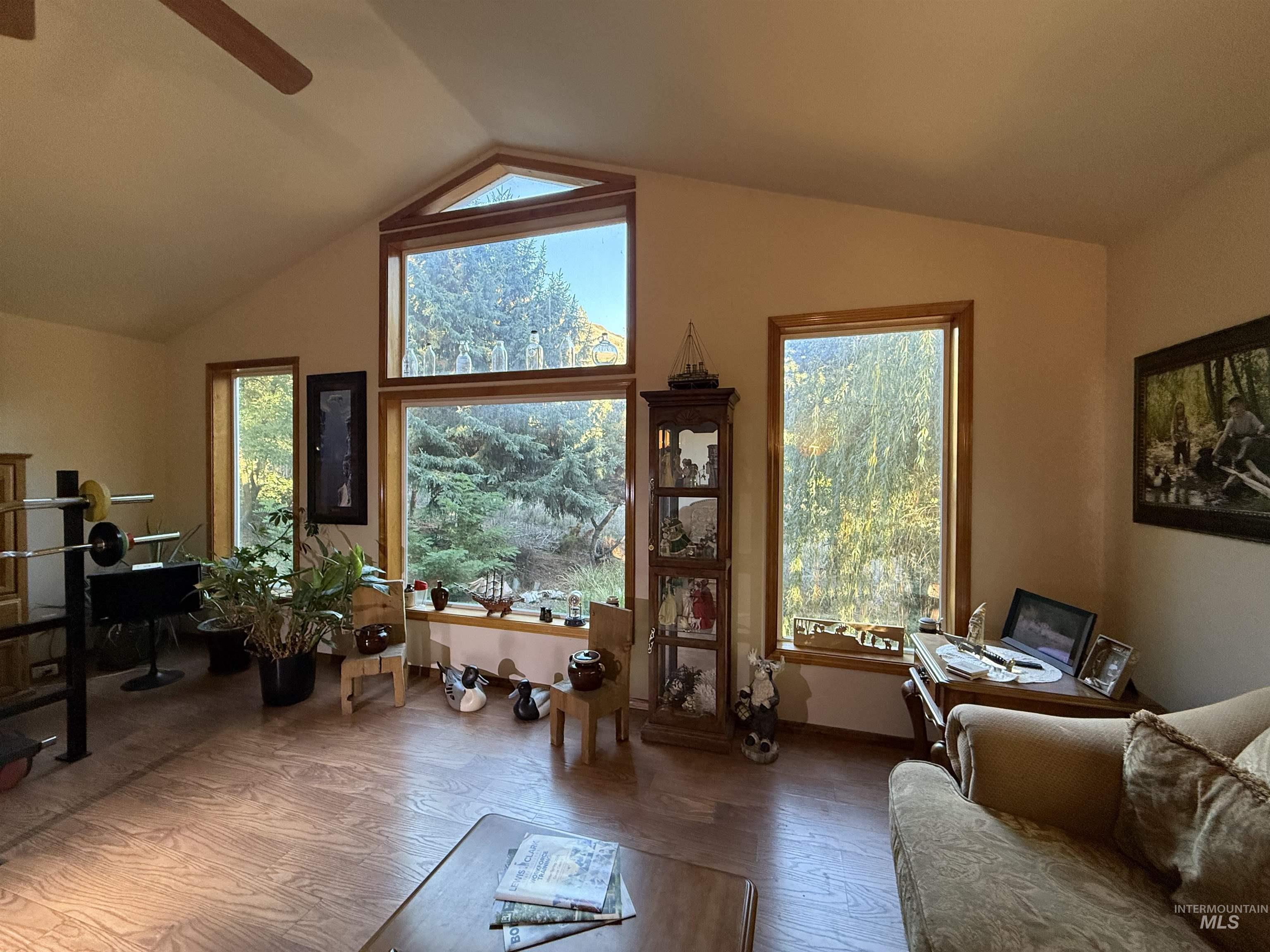 3210 Highway 162 Kamiah, ID 83536 - Photo 20 of 28 Living area with wood finished floors, healthy amount of natural light, vaulted ceiling, and ceiling fan