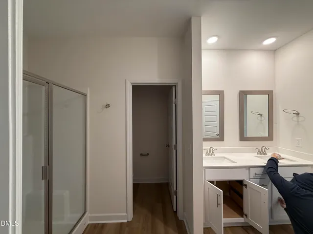 a en suite bathroom with a sink a mirror and a shower