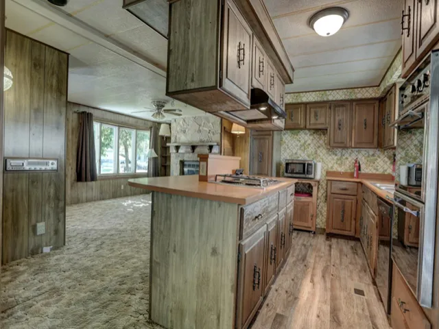a kitchen with stainless steel appliances granite countertop a large stove a sink dishwasher and a refrigerator