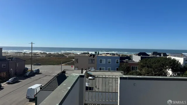 an outdoor view of a house with a lake view