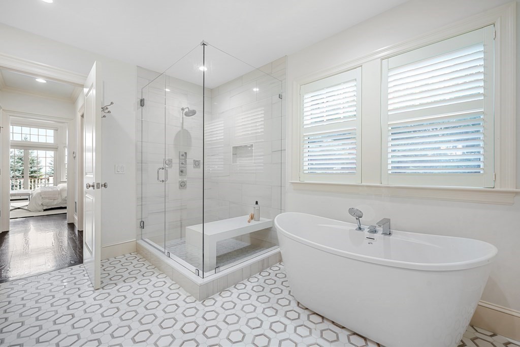 29 Pine Summit Circle, Unit 29 Weston, MA 02493 - Photo 18 of 30 a white bath tub sitting next to a shower
