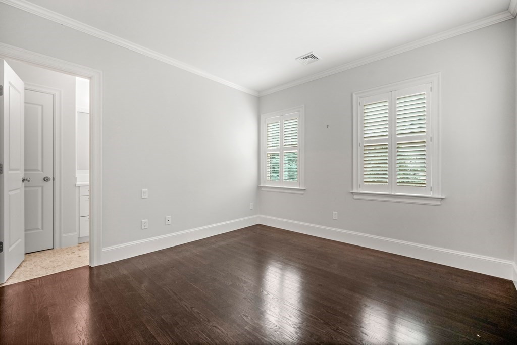 29 Pine Summit Circle, Unit 29 Weston, MA 02493 - Photo 22 of 30 an empty room with wooden floor and windows