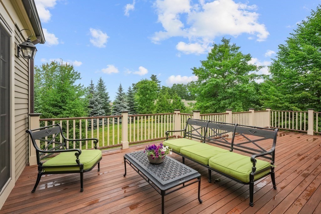 29 Pine Summit Circle, Unit 29 Weston, MA 02493 - Photo 25 of 30 a view of a wooden deck with furniture