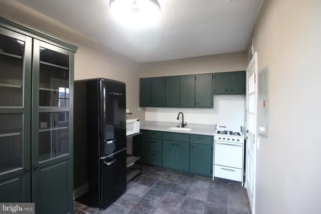 a kitchen with stainless steel appliances a refrigerator and a sink