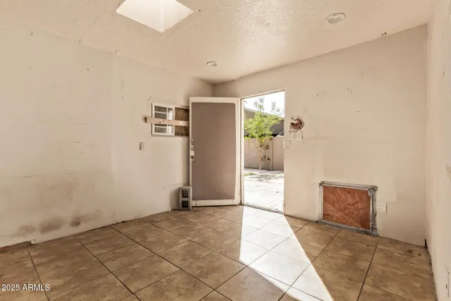 a view of a big room with windows and entryway