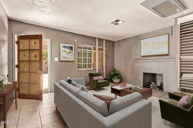 a living room with furniture and a fireplace