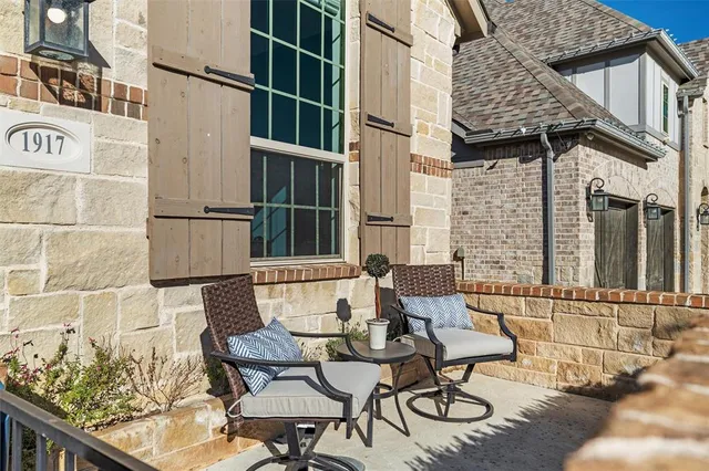 a view of a patio with table and chairs and potted plants