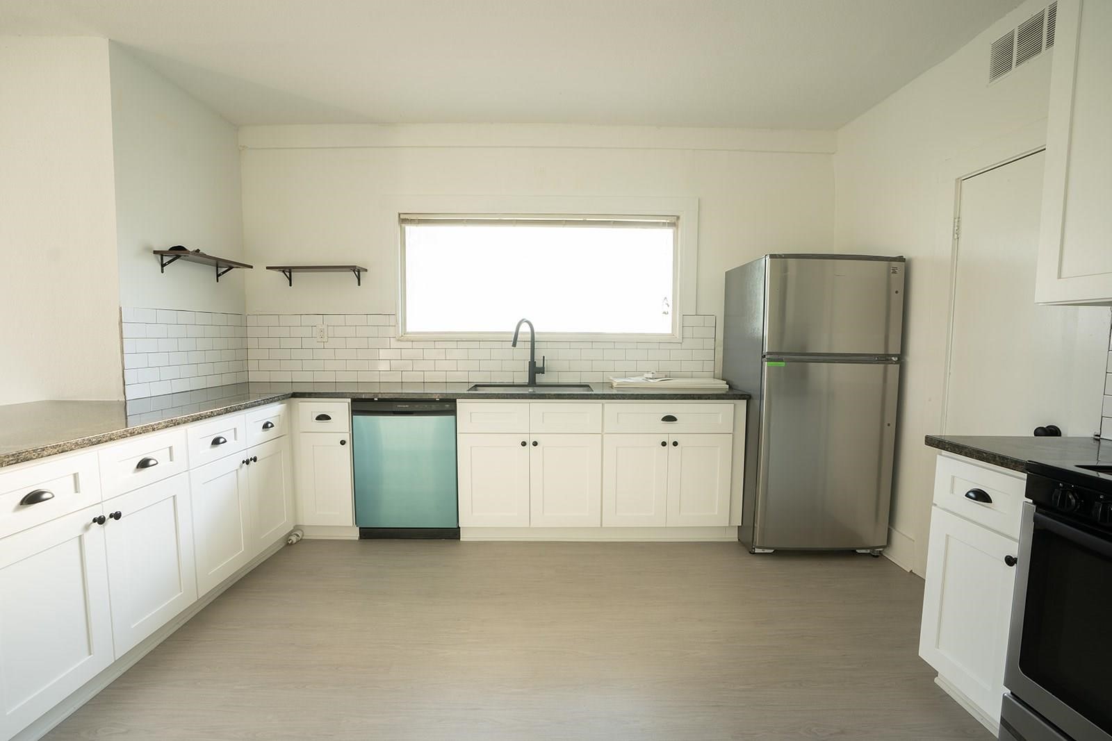 14711 Barak Road Guy, TX 77444 - Photo 4 of 8 a kitchen with granite countertop white cabinets white appliances and sink