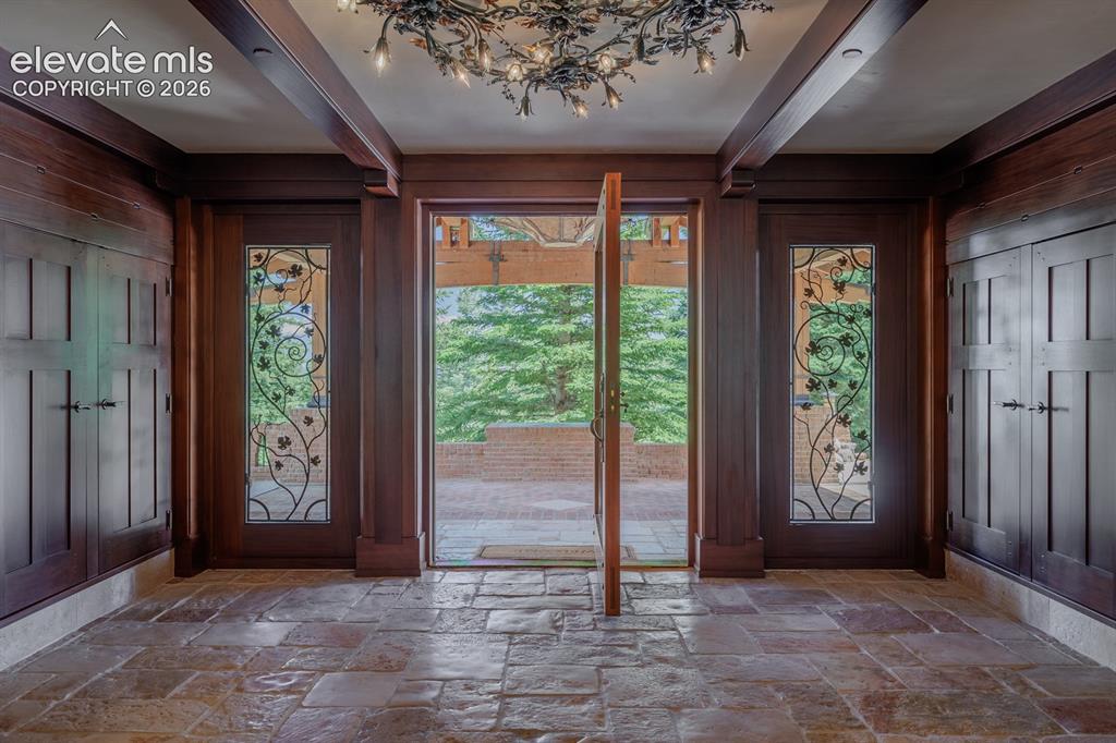 4530 Governors Point Colorado Springs, CO 80906 - Photo 7 of 49 Jerusalem stone in entry way and main garage walk way into the home. Pivoting front door with a grapevine design by blacksmith artisan Butch Lee