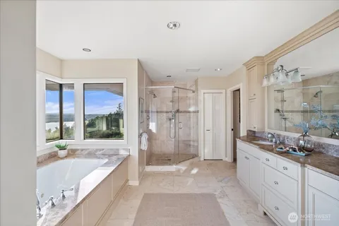 a bathroom with a granite countertop tub sink shower and a mirror