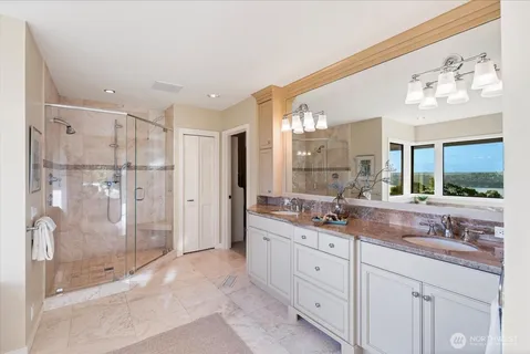 a bathroom with a granite countertop sink mirror and double