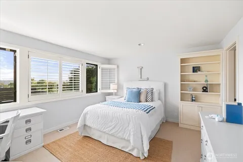 a bedroom with a bed and a desk