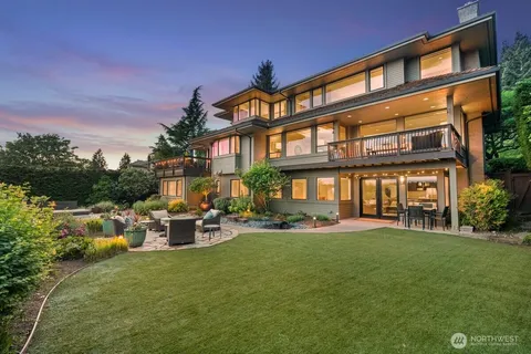 a view of a house with backyard sitting area and garden