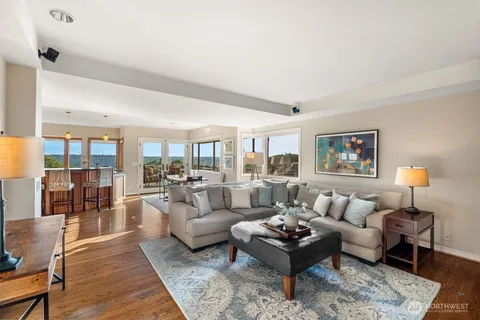 a living room with furniture and view of kitchen
