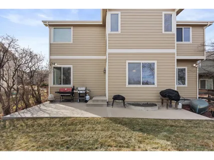 a view of a house with backyard and sitting area