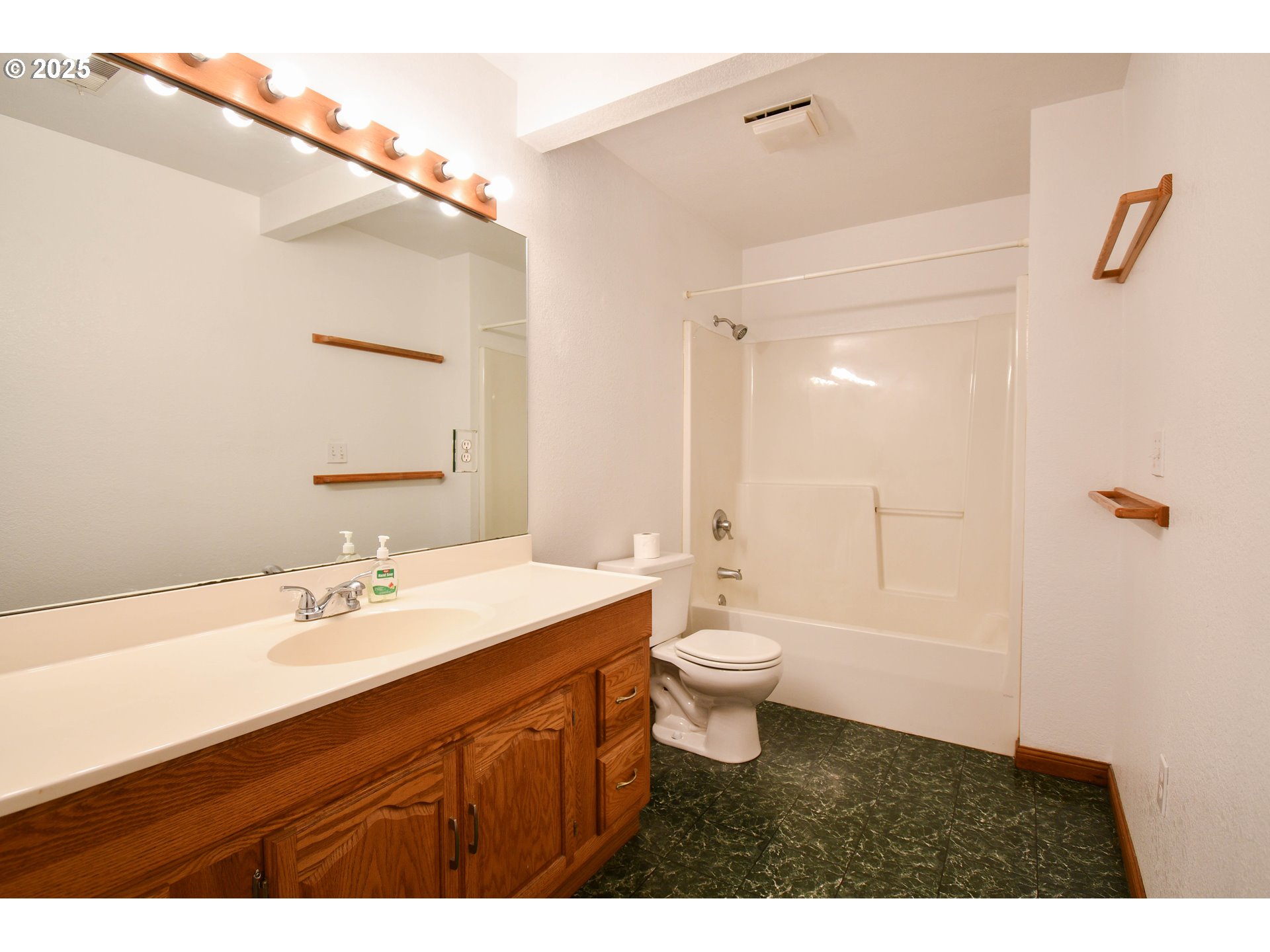 1731 Southeast Hamilton Street Roseburg, OR 97470 - Photo 15 of 23 a bathroom with a sink a toilet a tub and a mirror