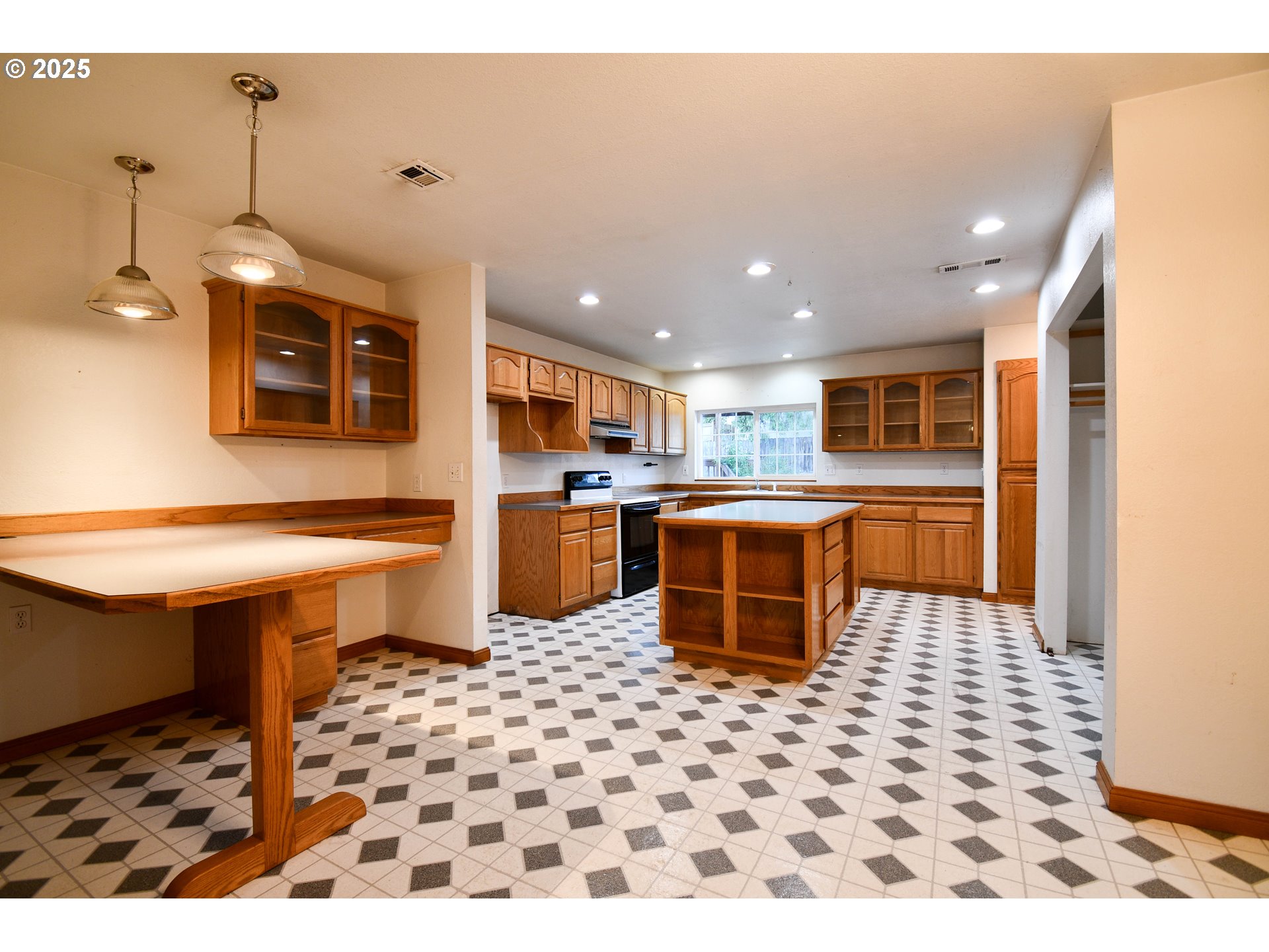 1731 Southeast Hamilton Street Roseburg, OR 97470 - Photo 6 of 23 a kitchen with stainless steel appliances kitchen island granite countertop a sink and a refrigerator