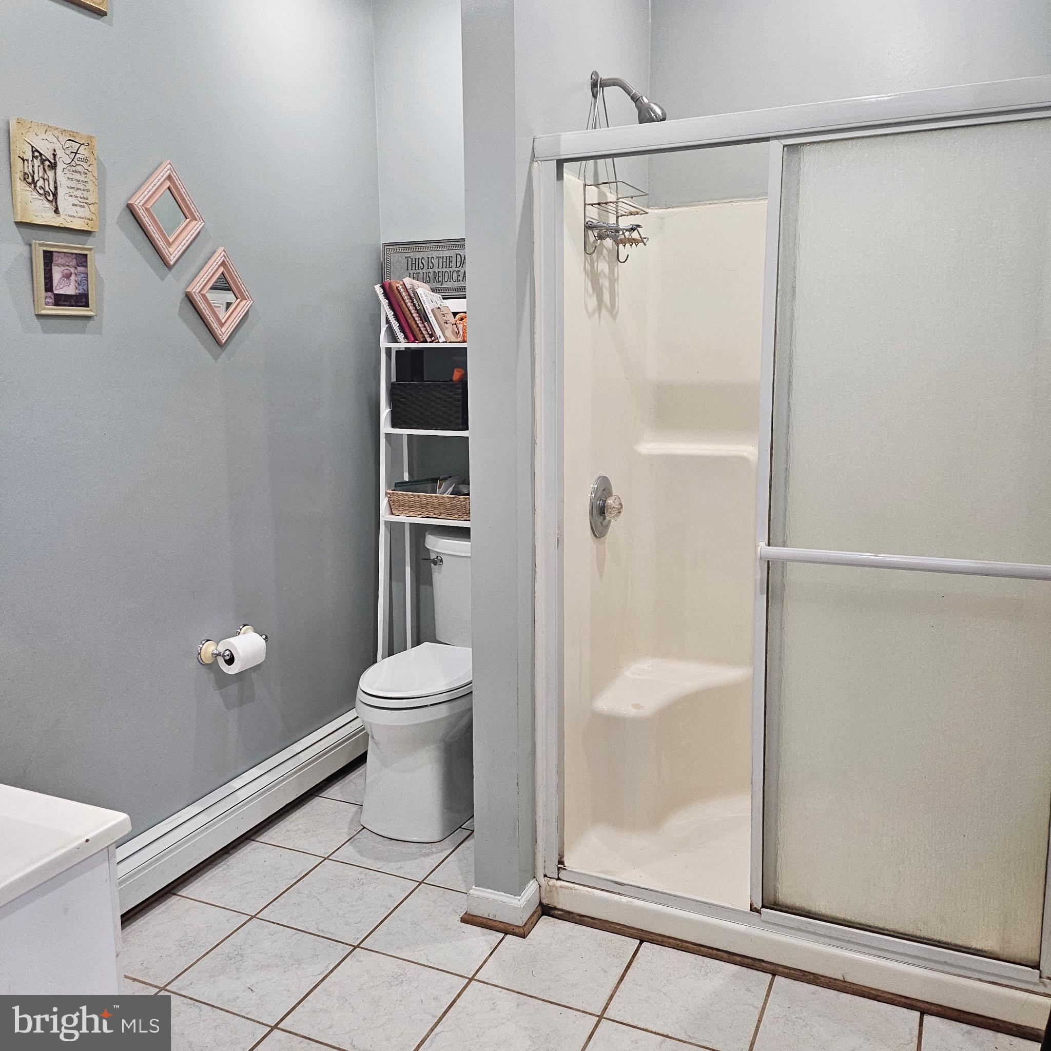 9348 Bastable Mill Road Catlett, VA 20119 - Photo 7 of 20 a bathroom with a granite countertop toilet and a shower