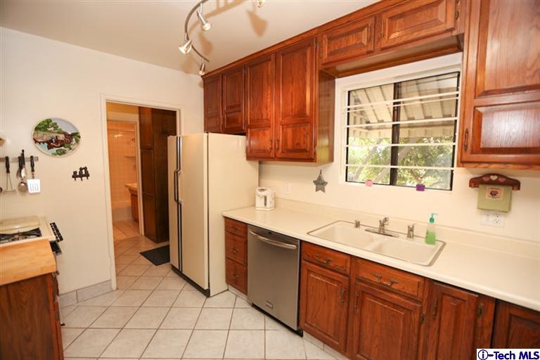 324 East Ramona Road Alhambra, CA 91801 - Photo 17 of 72 a kitchen with stainless steel appliances a refrigerator sink and cabinets