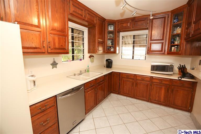 324 East Ramona Road Alhambra, CA 91801 - Photo 18 of 72 a kitchen with stainless steel appliances a sink window and cabinets
