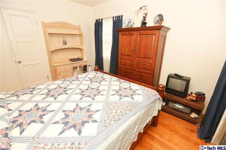 324 East Ramona Road Alhambra, CA 91801 - Photo 31 of 72 a bedroom with a bed and wooden floor