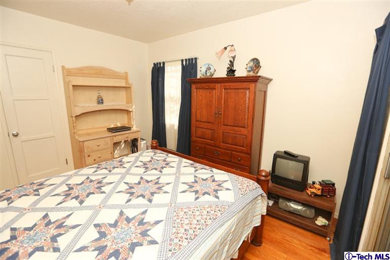 324 East Ramona Road Alhambra, CA 91801 - Photo 32 of 72 a bedroom with a bed and wooden floor