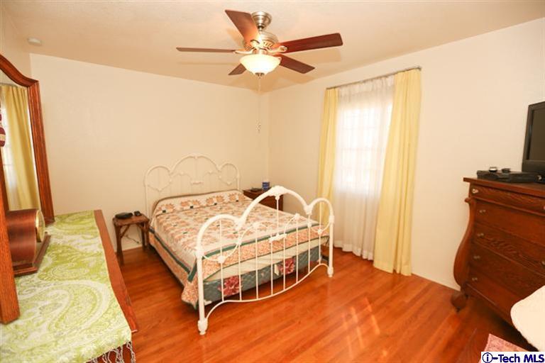 324 East Ramona Road Alhambra, CA 91801 - Photo 35 of 72 a bedroom with a bed and a chandelier