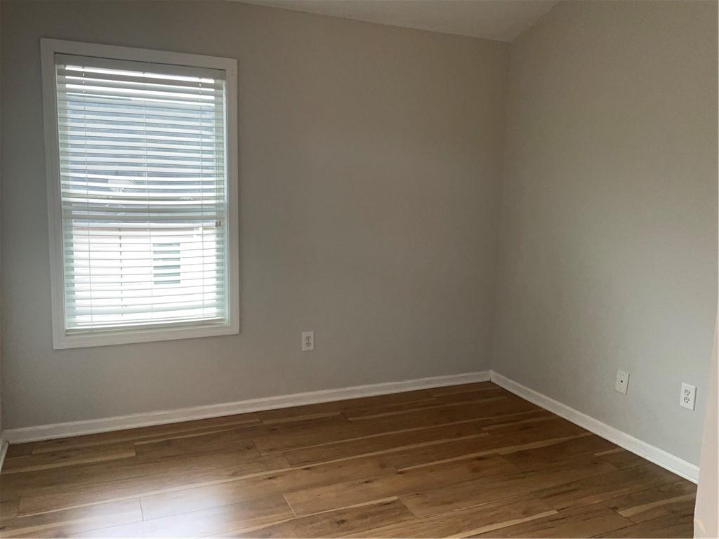 2555 Flat Shoals Road, Unit 1703 Atlanta, GA 30349 - Photo 16 of 26 a view of a room with wooden floor and a window