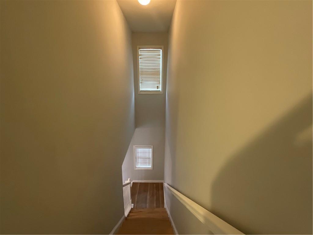 2555 Flat Shoals Road, Unit 1703 Atlanta, GA 30349 - Photo 10 of 26 a view of a hallway with wooden floor and a white door
