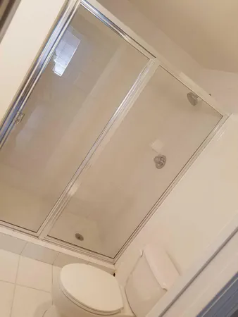 a bathroom with a toilet and a shower