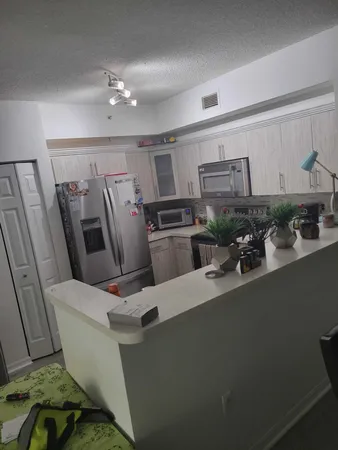 a view of a living room with furniture and a kitchen