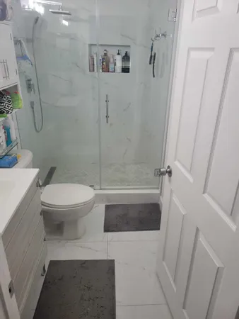 a bathroom with a toilet and a shower