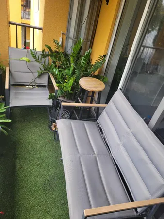 a balcony with table and chairs with wooden floor