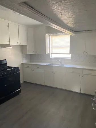 a kitchen with a sink and cabinets